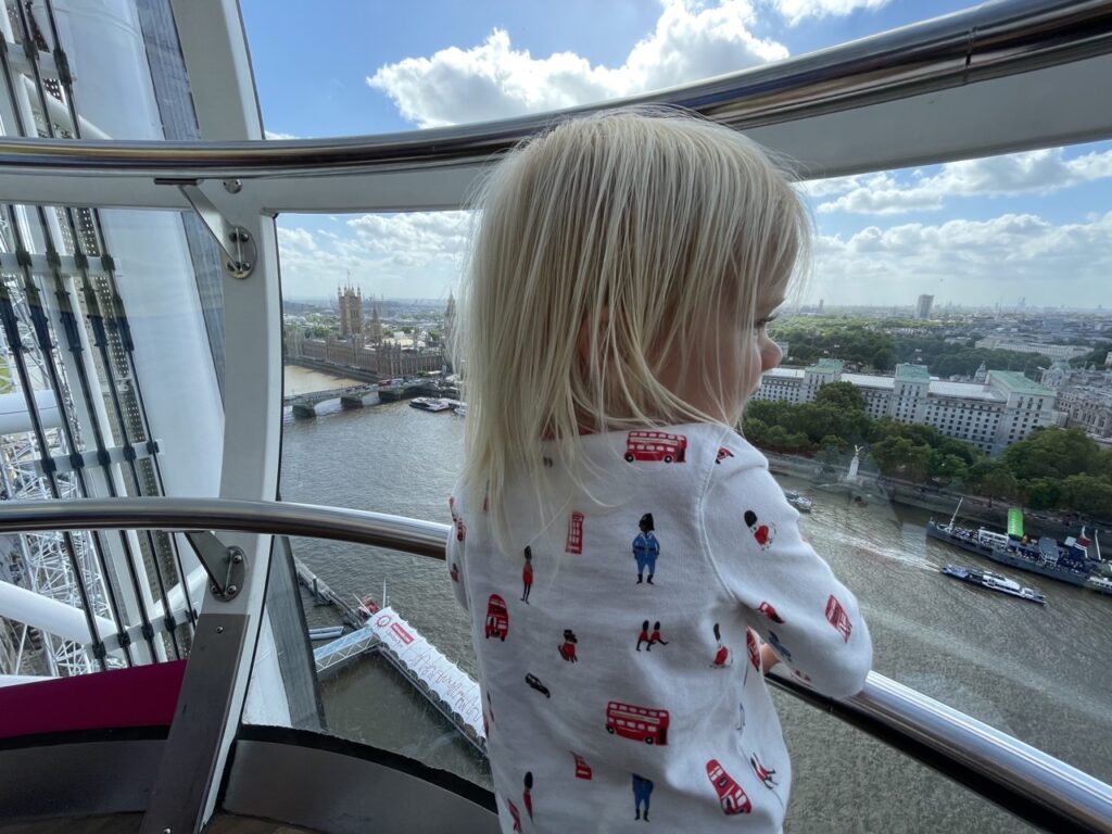 Toddler looks out from inside the London Eye